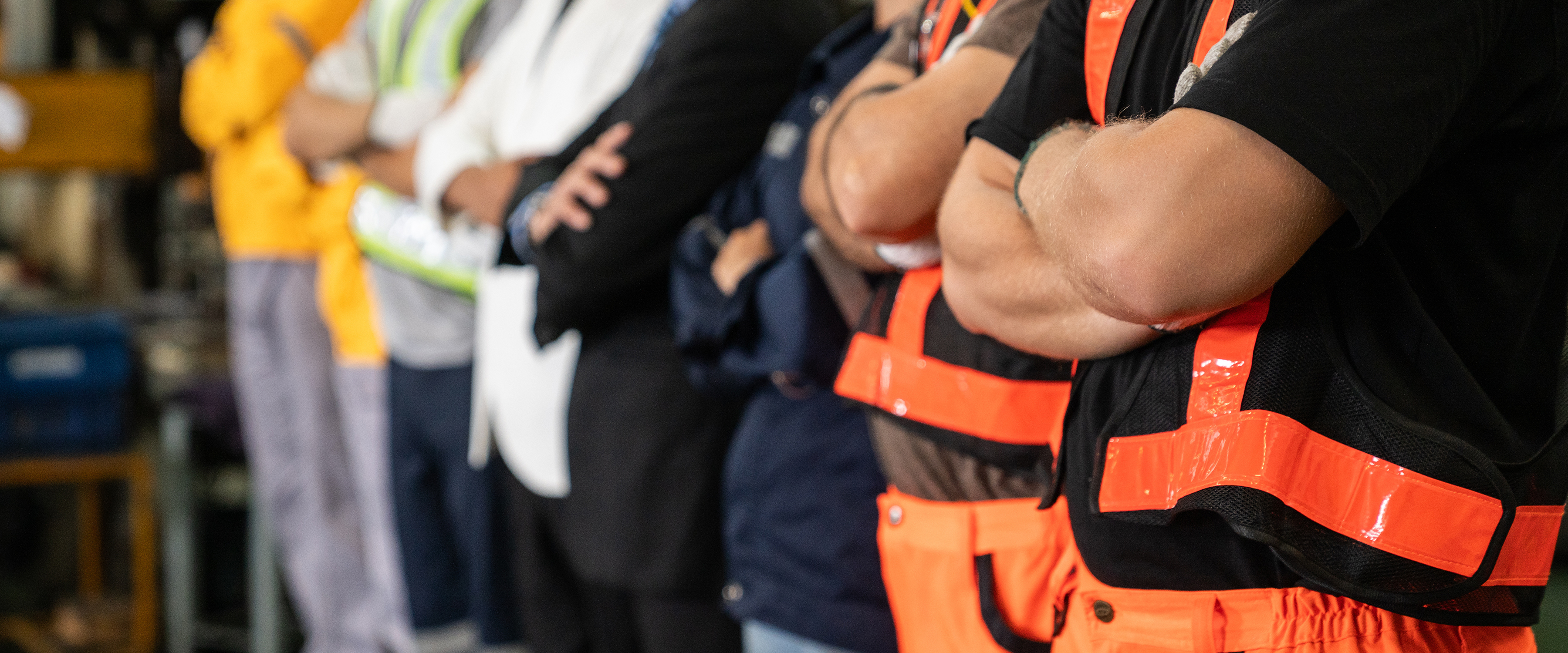 Construction colleagues wearing workwear and high-visibility safety equipment