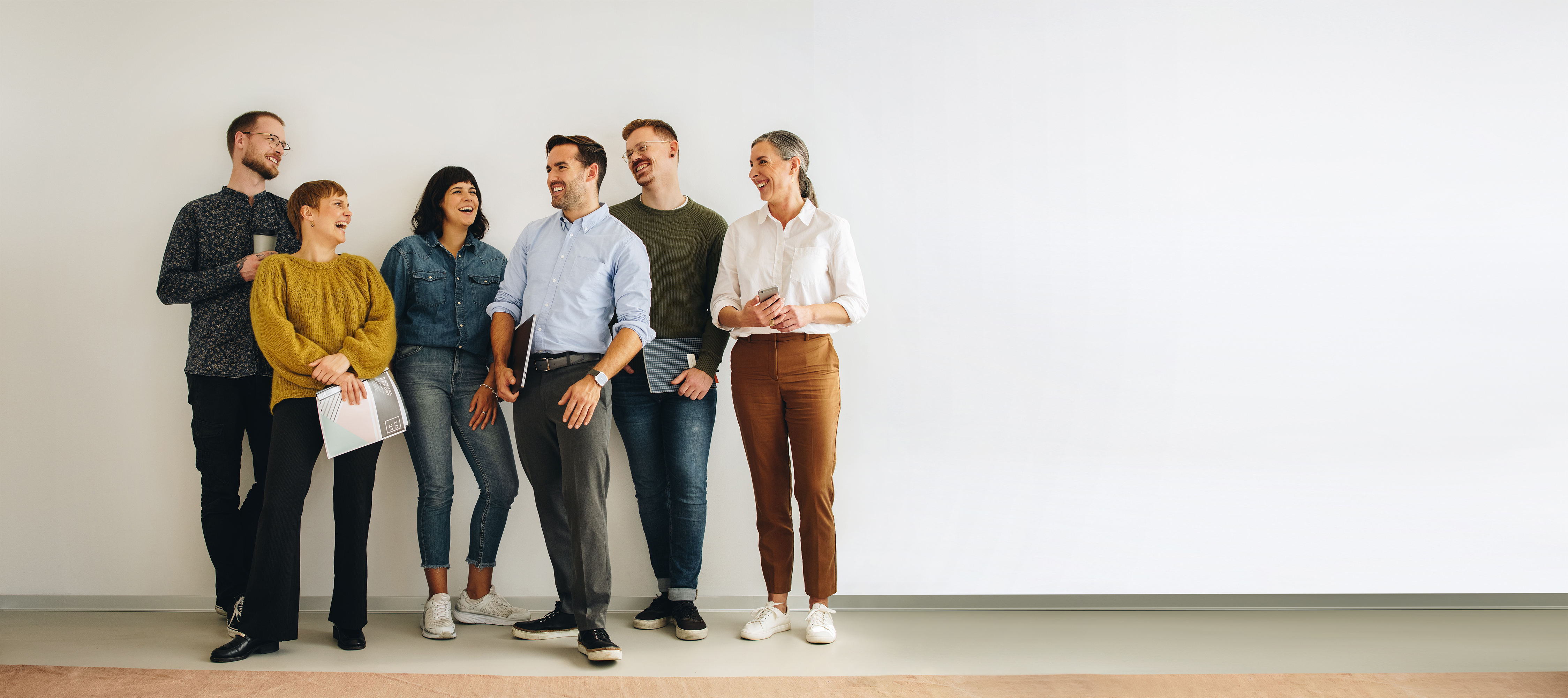 A group of colleagues sharing a conversation in an office